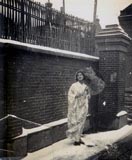 My mother, Girgee, dressed in a Japanese kimono with parasol, standing on snow in our laneway at 640 Seymour Road. (1938)